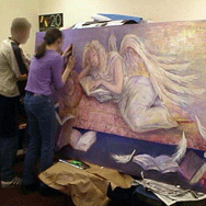 Students painting large landscape canvas of an angel